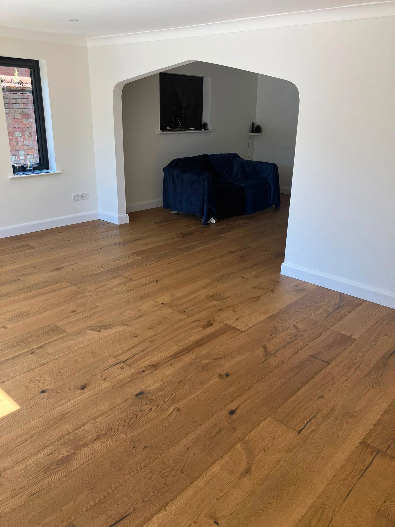 Natural wood planks fitted around a living room fireplace