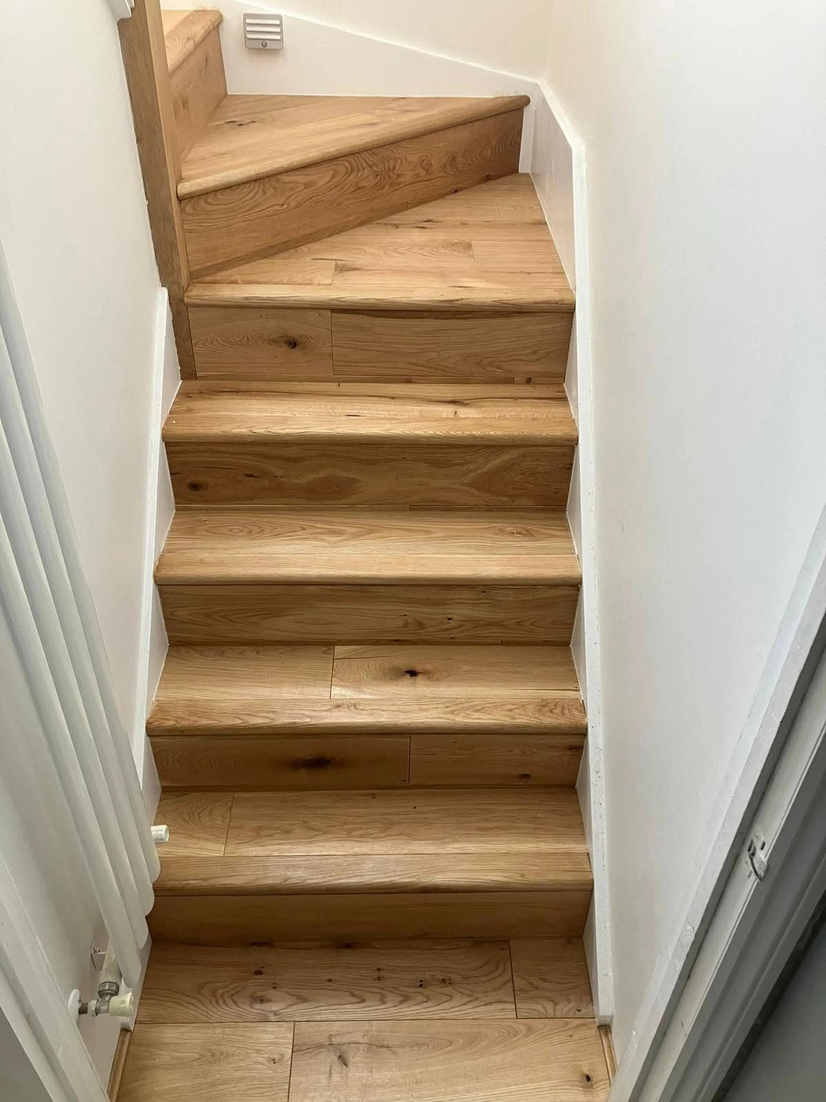 Wood flooring carefully fitted to a turning staircase